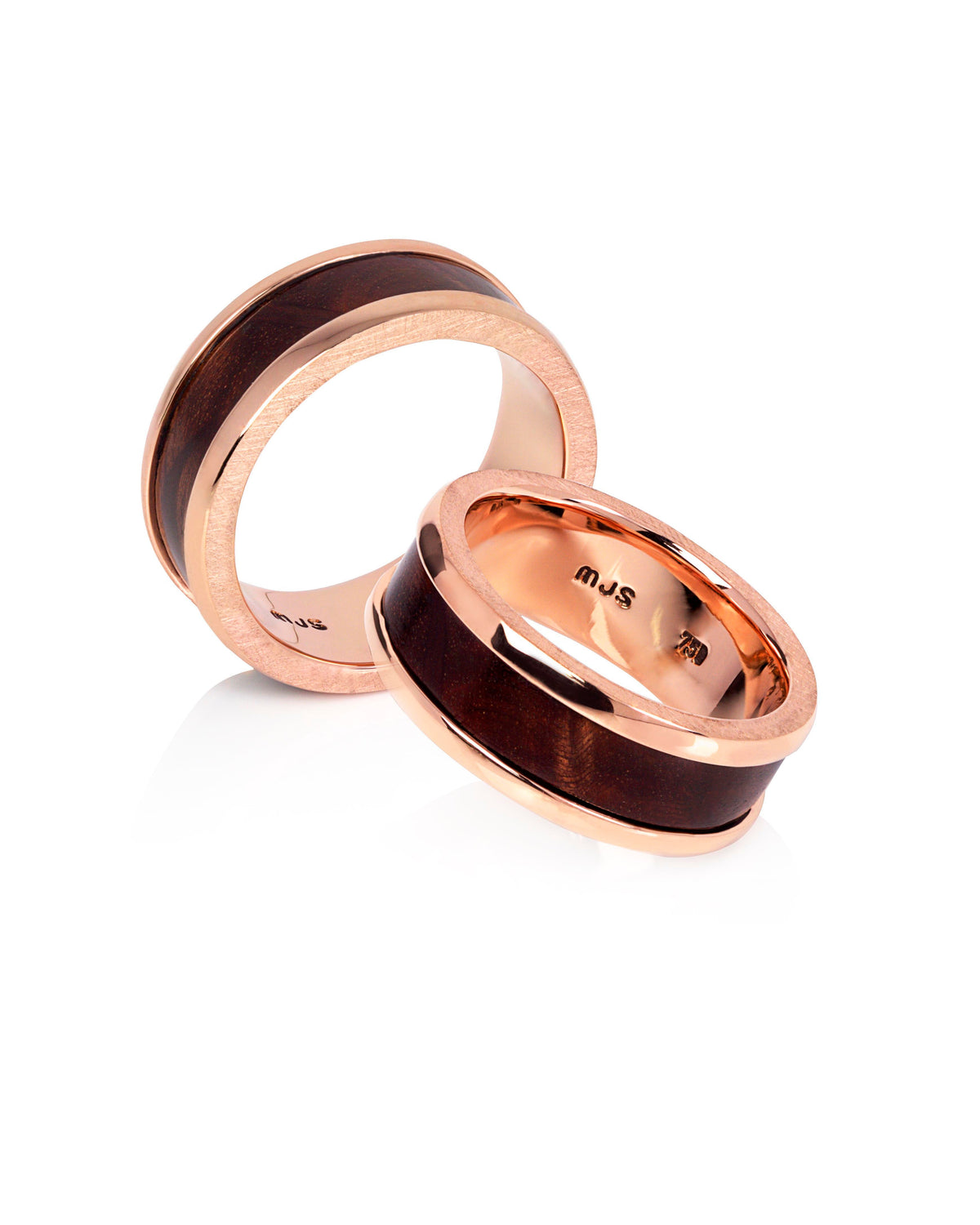 A pair of 18ct rose gold men's bands with flame she-oak timber inlay, displayed on a white background.