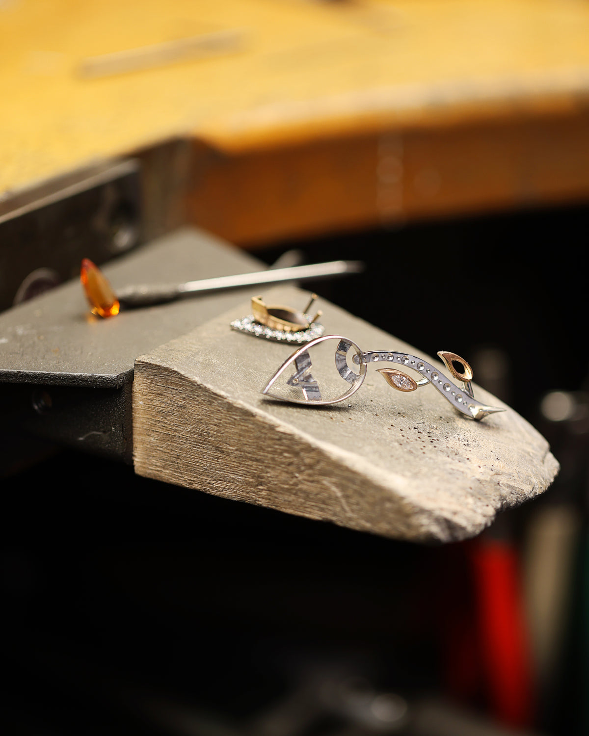 Construction of brooch with a unique design on a stone surface, with a blurred background