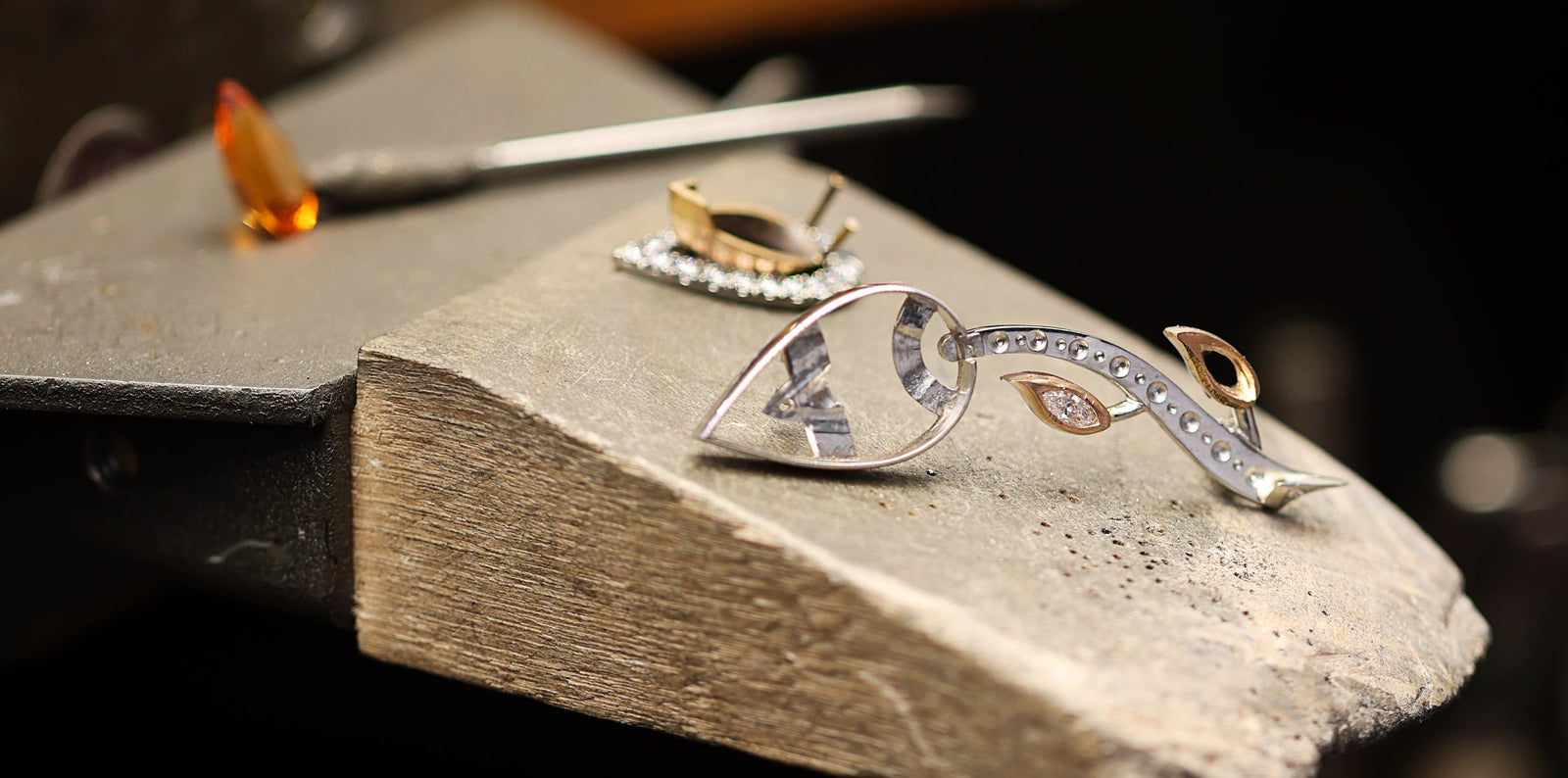 Construction of brooch with a unique design on a stone surface, with a blurred background