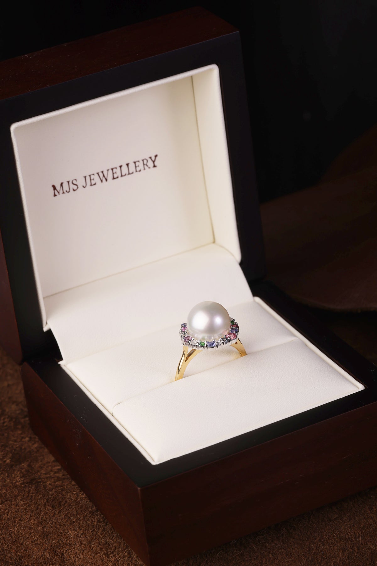 Australian South Sea Pearl surrounded by a medley of Precious Gemstones dress ring.