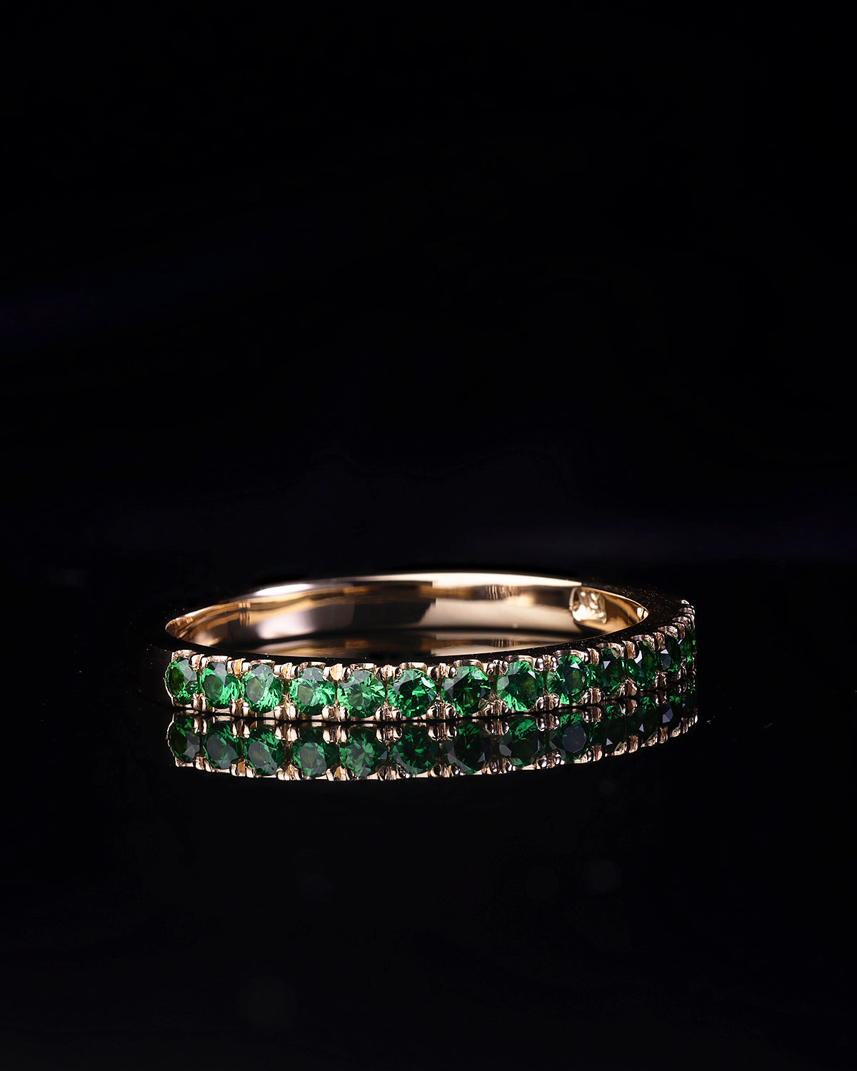 Handcrafted 18ct Yellow Gold band half set with vivid green Tsavorite garnets.