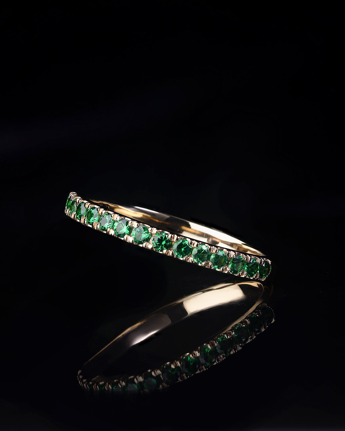 Handcrafted 18ct Yellow Gold band half set with vivid green Tsavorite garnets.